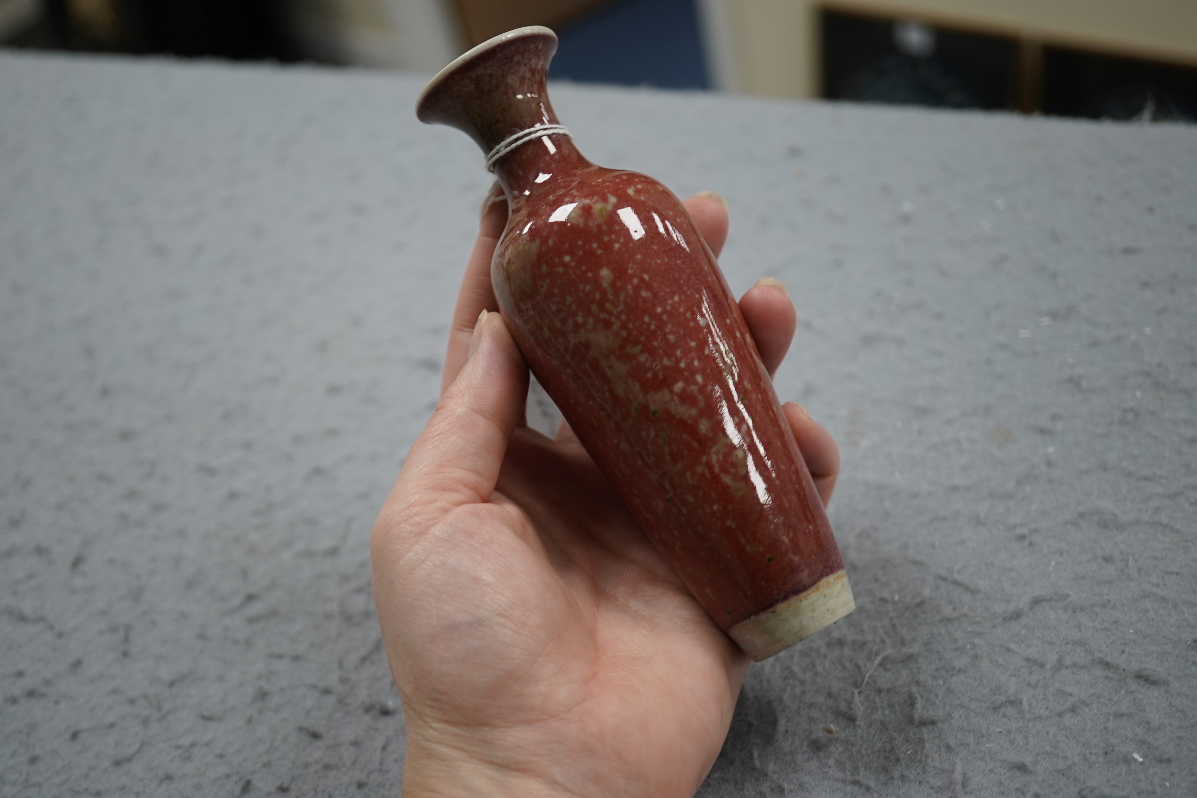 A small Chinese peach bloom glazed vase with fitted wood stand, Republic period